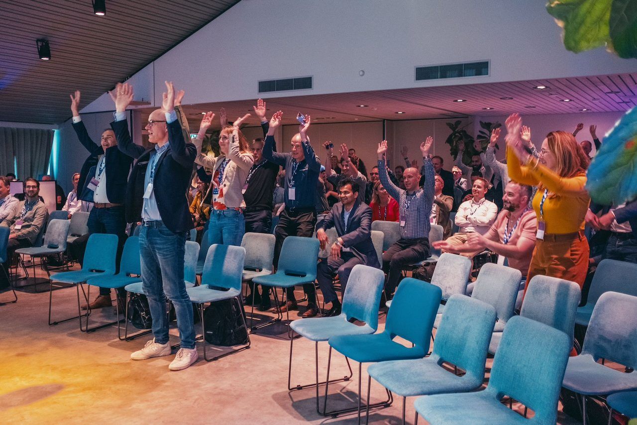 Workshop participants standing with their hands raised