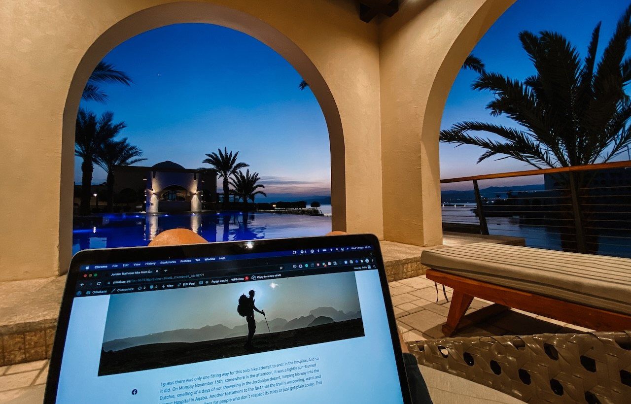 Laptop under an arch with a pool view in Aqaba, Jordan